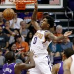 Phoenix Suns forward Marquese Chriss (0) dunks over Sacramento Kings forward Zach Randolph (50) during the first half of an NBA basketball game, Monday, Oct. 23, 2017, in Phoenix. (AP Photo/Matt York)