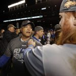 Los Angeles Dodgers manager Dave Roberts and Justin Turner celebrate after Game 5 of baseball's National League Championship Series against the Chicago Cubs, Thursday, Oct. 19, 2017, in Chicago. The Dodgers won 11-1 to win the series and advance to the World Series. (AP Photo/Matt Slocum)