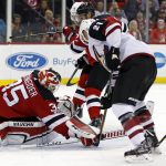 New Jersey Devils goalie Cory Schneider makes a save on a shot by Arizona Coyotes' Derek Stepan (21) during the third period of an NHL hockey game, Saturday, Oct. 28, 2017, in Newark, N.J. The Devils won 4-3. (AP Photo/Adam Hunger)