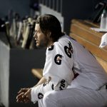 Los Angeles Dodgers starting pitcher Clayton Kershaw sits in the dugout during the second inning of Game 1 of the baseball team's National League Division Series against the Arizona Diamondbacks in Los Angeles, Friday, Oct. 6, 2017. (AP Photo/Jae C. Hong)