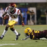 Southern California wide receiver Tyler Vaughns (21) eludes the tackle of Arizona State defensive back Kobe Williams on a touchdown catch and run during the first half of an NCAA college football game, Saturday, Oct. 28, 2017, in Tempe, Ariz. (AP Photo/Ralph Freso)