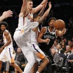 Brooklyn Nets guard Spencer Dinwiddie (8) passes in front of Phoenix Suns forward Jared Dudley (3) in the first half of an NBA basketball game, Tuesday, Oct. 31, 2017, in New York. (AP Photo/Kathy Willens)