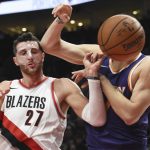 Portland Trail Blazers center Jusuf Nurkic gets an elbow to the side of his head as he vies for a rebound with Phoenix Suns center Alex Len during the second half of an NBA basketball preseason game in Portland, Ore., Tuesday, Oct. 3, 2017. (AP Photo/Steve Dykes)