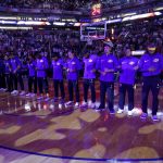 The Los Angeles Lakers lock arms during the national anthem prior to an NBA basketball game against the Phoenix Suns, Friday, Oct. 20, 2017, in Phoenix. (AP Photo/Matt York)