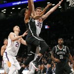 Phoenix Suns forward Dragan Bender (35) blocks a shot by Brooklyn Nets guard Spencer Dinwiddie, center, as Suns center Alex Len (21) watches from the floor in the first half of an NBA basketball game, Tuesday, Oct. 31, 2017, in New York. (AP Photo/Kathy Willens)