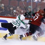 Arizona Coyotes left wing Lawson Crouse (67) and Dallas Stars defenseman Marc Methot (33) collide against the boards during the second period of an NHL hockey game Thursday, Oct. 19, 2017, in Glendale, Ariz. (AP Photo/Ross D. Franklin)