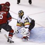 Arizona Coyotes right wing Tobias Rieder (8) sends the puck past Vegas Golden Knights goalie Marc-Andre Fleury (29) as Coyotes' center Brad Richardson (15) looks on during the first period of an NHL hockey game Saturday, Oct. 7, 2017, in Glendale, Ariz. (AP Photo/Ross D. Franklin)