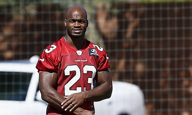 New Arizona Cardinals running back Adrian Peterson walks to a practice field during practice at the...