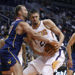 Phoenix Suns center Alex Len, right, and Brisbane Bullets forward Anthony Petrie battle for a loose ball under the basket during the first half of an NBA exhibition basketball game Friday, Oct. 13, 2017, in Phoenix. (AP Photo/Ralph Freso)
