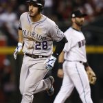 Colorado Rockies third baseman Nolan Arenado (28) rounds the bases after hitting a solo home as Arizona Diamondbacks' Daniel Descalso looks away during the eighth inning of the National League wild-card playoff baseball game, Wednesday, Oct. 4, 2017, in Phoenix. (AP Photo/Ross D. Franklin)