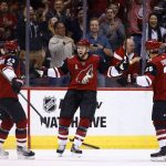 Arizona Coyotes center Derek Stepan, middle, celebrates his goal against the Dallas Stars with Coyotes defenseman Oliver Ekman-Larsson (23) and center Nick Cousins (25) during the first period of an NHL hockey game Thursday, Oct. 19, 2017, in Glendale, Ariz. (AP Photo/Ross D. Franklin)