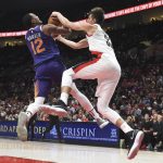 Phoenix Suns forward TJ Warren and Portland Trail Blazers center Zach Collins go after a ball during the second half of an NBA basketball preseason game in Portland, Ore., Tuesday, Oct. 3, 2017. (AP Photo/Steve Dykes)