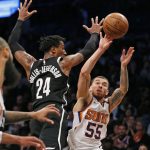 Phoenix Suns guard Mike James (55) passes to Suns center Tyson Chandler, far left, maneuvering around Brooklyn Nets forward Rondae Hollis-Jefferson (24), in the second half of an NBA basketball game, Tuesday, Oct. 31, 2017, in New York. The Suns defeated the Nets 122-114. (AP Photo/Kathy Willens)