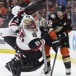 Anaheim Ducks right wing Corey Perry, right, trips Arizona Coyotes goalie Louis Domingue resulting in a goalie interference penalty during the second period of an NHL hockey game in Anaheim, Calif., Thursday, Oct. 5, 2017. (AP Photo/Kelvin Kuo)