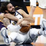 Utah Jazz guard Ricky Rubio, front, battles for a loose ball with Phoenix Suns guard Devin Booker during the first half of a preseason NBA basketball game Friday, Oct. 6, 2017, in Salt Lake City. (AP Photo/Rick Bowmer)