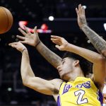 Los Angeles Lakers guard Lonzo Ball (2) dishes off against the Phoenix Suns during the first half of an NBA basketball game, Friday, Oct. 20, 2017, in Phoenix. (AP Photo/Matt York)