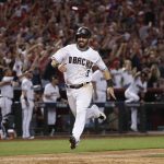Arizona Diamondbacks' Daniel Descalso (3) scores on a two-run triple by Archie Bradley during the seventh inning of the National League wild-card playoff baseball game against the Colorado Rockies, Wednesday, Oct. 4, 2017, in Phoenix. (AP Photo/Matt York)