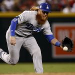 Los Angeles Dodgers Justin Turner (10) fields a ground out by Arizona Diamondbacks starting pitcher Zack Greinke during the third inning of game 3 of baseball's National League Division Series, Monday, Oct. 9, 2017, in Phoenix. (AP Photo/Ross D. Franklin)