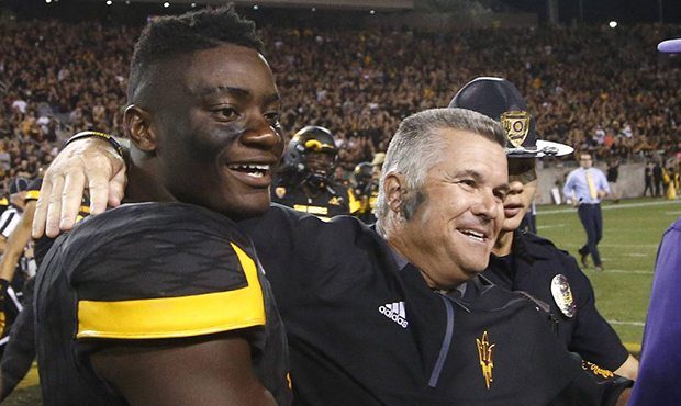 Arizona State head coach Todd Graham, right, celebrates with linebacker Christian Sam, left, after ...