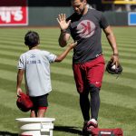 Arizona Diamondbacks' Gregor Blanco high-fives his son, Gregor Blanco Jr., after playing catch before a workout for the National League wild card playoff baseball game, Tuesday, Oct. 3, 2017, in Phoenix. The Diamondbacks face the Colorado Rockies in a single game elimination playoff game on Wednesday. (AP Photo/Matt York)