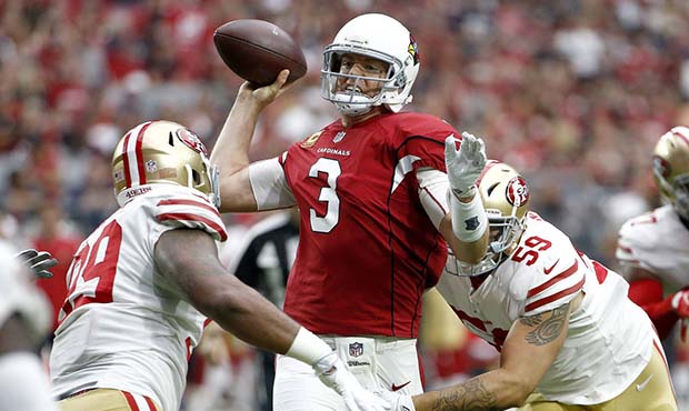 Arizona Cardinals quarterback Carson Palmer (3) is hit as he throws by San Francisco 49ers defensiv...