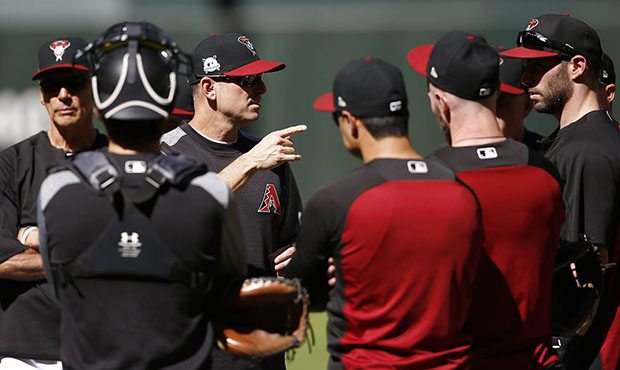 Arizona Diamondbacks manager Torey Lovullo, third from left, talks with his players during practice...