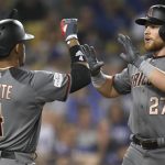 Arizona Diamondbacks' Brandon Drury, right, celebrates his three-run home run with Ketel Marte against the Los Angeles Dodgers during the seventh inning of Game 2 of baseball's National League Division Series in Los Angeles, Saturday, Oct. 7, 2017. (AP Photo/Mark J. Terrill)