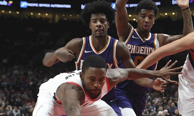 Portland Trail Blazers forward Maurice Harkless loses the ball out of bounds as Phoenix Suns forwar...