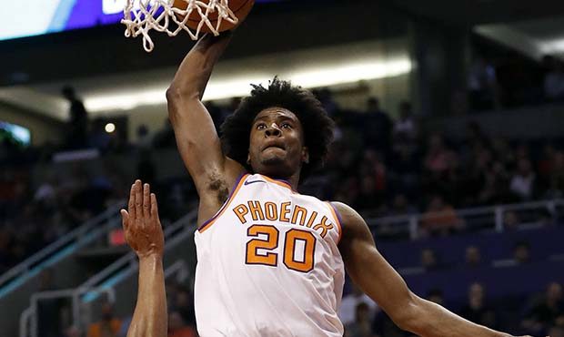 Phoenix Suns forward Josh Jackson (20) shoots over Portland Trail Blazers guard Evan Turner during ...