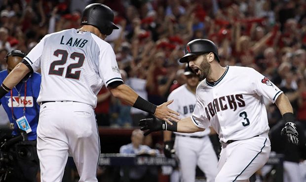 Arizona Diamondbacks' Daniel Descalso (3) is greeted by Jake Lamb (22) after Descalso's two-run hom...