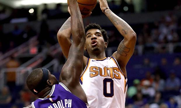 Phoenix Suns forward Marquese Chriss (0) shoots over Sacramento Kings forward Zach Randolph (50) du...