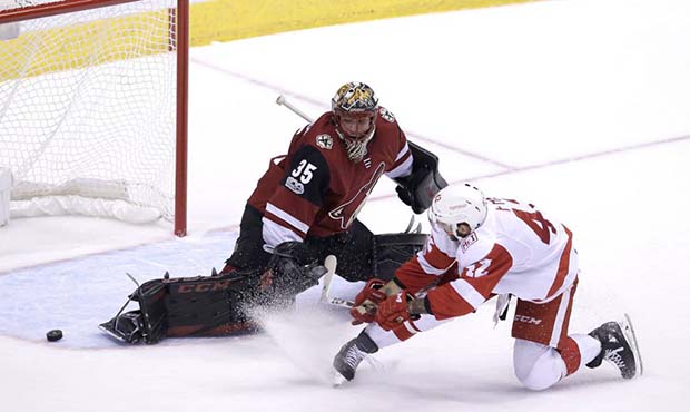 Arizona Coyotes goalie Louis Domingue (35) turns away a shot by Detroit Red Wings right wing Martin...
