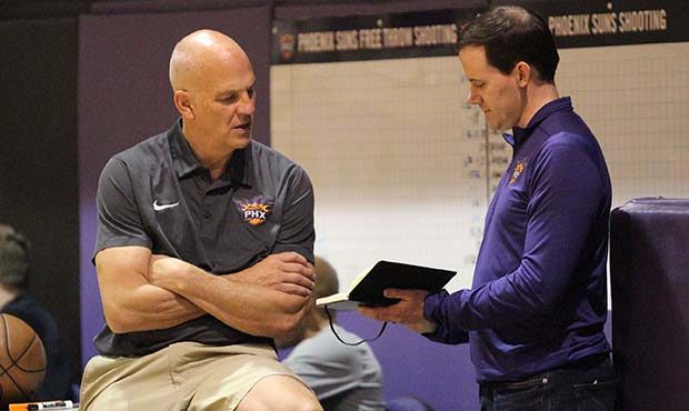 Phoenix Suns interim head coach Jay Triano strategizes with General Manager Ryan McDonough during p...
