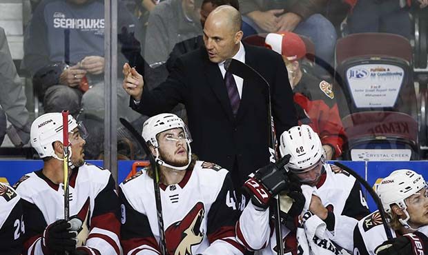 Arizona Coyotes' head coach Rick Tocchet, center, gives instruction to players during the first per...