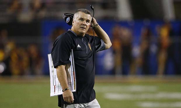 Arizona State coach Todd Graham stands on the field during the first half of the team's NCAA colleg...