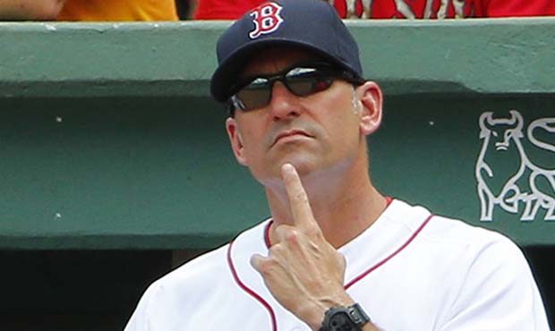 Boston Red Sox interim manager Torey Lovullo sends in signals during the third inning of a baseball...
