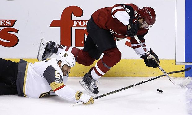 Arizona Coyotes right wing Tobias Rieder (8) gets tripped up by Vegas Golden Knights defenseman Der...