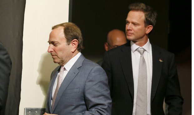 NHL Commissioner Gary Bettman, left, arrives at a news conference with new Phoenix Coyotes' co-owne...