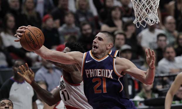 Phoenix Suns center Alex Len, right, rebounds against Portland Trail Blazers forward Ed Davis durin...