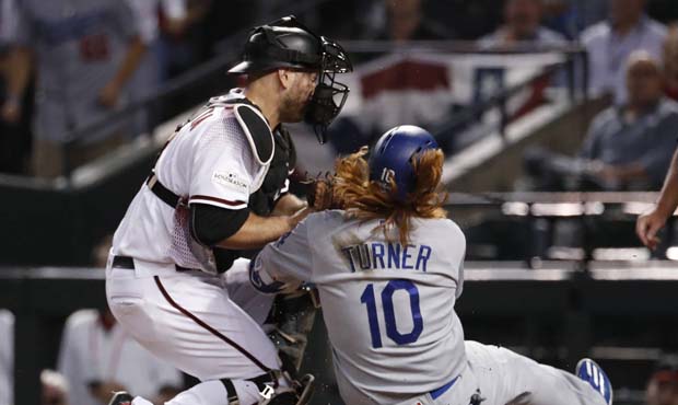 Los Angeles Dodgers' Justin Turner (10) is tagged out by Arizona Diamondbacks catcher Chris Iannett...