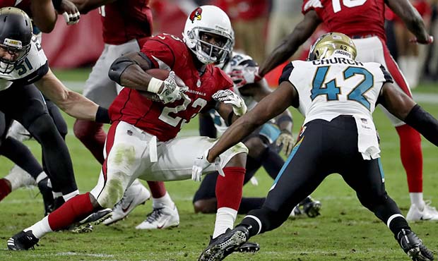 Arizona Cardinals running back Adrian Peterson (23) tries to avoid Jacksonville Jaguars strong safe...