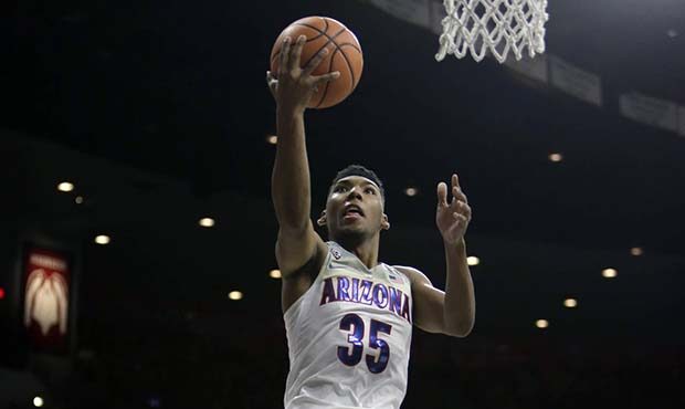 Arizona guard Allonzo Trier (35) drives past Northern Arizona forward Lenell Henry in the second ha...