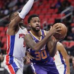 Phoenix Suns guard Troy Daniels (30) goes to the basket past Detroit Pistons guard Langston Galloway (9) during the first half of an NBA basketball game Wednesday, Nov. 29, 2017 in Detroit. (AP Photo/Duane Burleson)