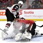 Ottawa Senators goaltender Mike Condon (1) is showered in ice as Arizona Coyotes' Anthony Duclair (10) scores against him during the first period of an NHL hockey game in Ottawa, Saturday, Nov. 18, 2017. (Justin Tang/The Canadian Press via AP)
