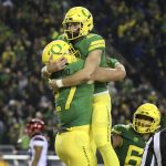 Oregon's Jacob Breeland, left, celebrates with quarterback Justin Herbert after scoring a touchdown against Arizona during the second quarter of an NCAA college football game, Saturday, Nov. 18, 2017, in Eugene, Ore. (AP Photo/Chris Pietsch)