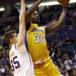 Los Angeles Lakers forward Julius Randle (30) goes up for a shot against Phoenix Suns forward Dragan Bender (35) during the first half of an NBA basketball game Monday, Nov. 13, 2017, in Phoenix. (AP Photo/Ross D. Franklin)