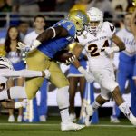 UCLA running back Bolu Olorunfunmi, right, breaks away form Arizona State defensive back Cody French during the first half of an NCAA college football game in Pasadena, Saturday, Nov. 11, 2017. (AP Photo/Chris Carlson)