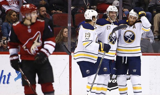 Buffalo Sabres left wing Benoit Pouliot (67) celebrates his goal against the Arizona Coyotes with d...