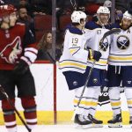 Buffalo Sabres left wing Benoit Pouliot (67) celebrates his goal against the Arizona Coyotes with defenseman Jake McCabe (19) and center Ryan O'Reilly, right, as Coyotes center Clayton Keller, left, skates away during the second period of an NHL hockey game Thursday, Nov. 2, 2017, in Glendale, Ariz. (AP Photo/Ross D. Franklin)