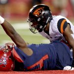 Arizona quarterback Khalil Tate (14) celebrates his touchdown, after dragging Oregon State safety Omar Hicks-Onu into the end zone during the second quarter of an NCAA college football game Saturday, Nov. 11, 2017, Tucson, Ariz. (Kelly Presnell/Arizona Daily Star via AP)